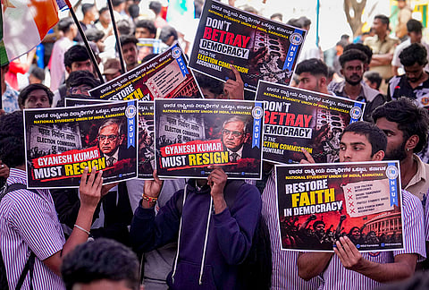 National Students' Union of India (NSUI) members and supporters hold placards during a protest demanding the resignation of Chief Election Commissioner Gyanesh Kumar at Freedom Park, in Bengaluru, Karnataka.
