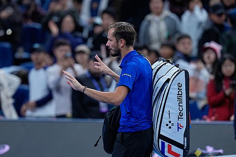 Daniil Medvedev, of Russia, leaves the court after being disqualified during a semi final match against Novak Djokovic, of Serbia at the China Open tennis tournament in Beijing, Monday, Oct. 5, 2026.
