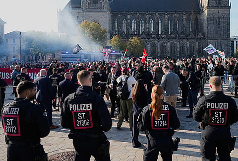 Police officers monitor a protest against the far-right AfD, Alternative for Germany, party prior to the constituent session of the new elected German federal state parliament of Saxony-Anhalt in Magdeburg, Germany, Tuesday, Oct. 6, 2026. 
