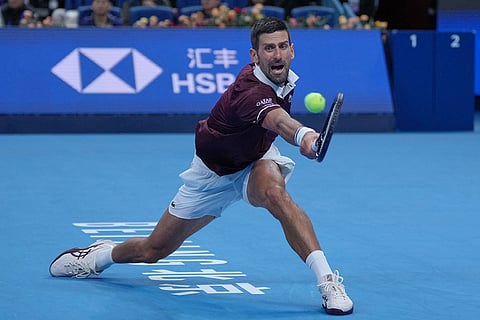 Novak Djokovic, of Serbia, returns a ball to Daniil Medvedev, of Russia, during the men's single semi-final match at the China Open tennis tournament in Beijing, Monday, Oct. 5, 2026.