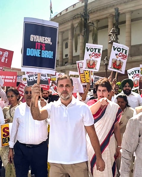 Leader of Opposition in the Lok Sabha Rahul Gandhi holds a placard reading 'Gyanesh, It's Done Bro!' alongside Congress leader Priyanka Gandhi Vadra during an INDIA bloc protest march from Parliament toward the Election Commission office, demanding the resignation of Chief Election Commissioner Gyanesh Kumar, in New Delhi. 

