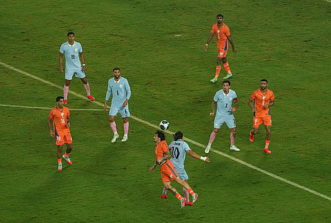 India's players, orange and Uruguay's players vie for the ball during an International friendly Football match between India and Uruguay, in Kolkata, Tuesday, Oct. 6, 2026.