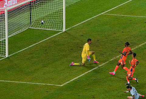 Uruguay's Maximiliano Araujo, 20, scores a goal as India's Gurpreet Singh Sandhu looks on during an International friendly Football match between India and Uruguay, in Kolkata, Tuesday, Oct. 6, 2026.