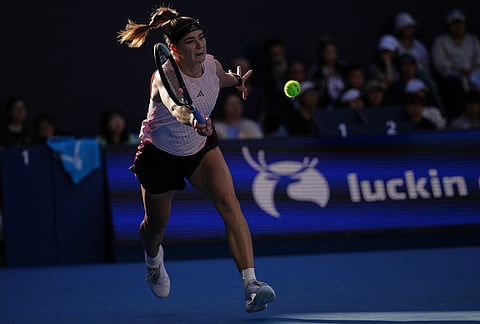 Karolina Muchova, of the Czech Republic, returns a ball to Naomi Osaka, of Japan, during the fourth round of the women's singles match at the China Open tennis tournament in Beijing, Tuesday, Oct. 6, 2026. 