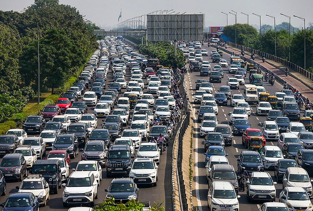 | Photo: PTI  : Heavy traffic movement and slow-moving vehicles seen on National Highway-24 near Akshardham following traffic diversions, in New Delhi.
