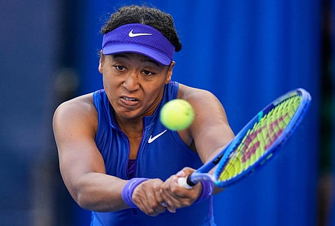 Naomi Osaka, of Japan, returns a ball to Karolina Muchova, of the Czech Republic, during the fourth round of the women's singles match at the China Open tennis tournament in Beijing, Tuesday, Oct. 6, 2026. 