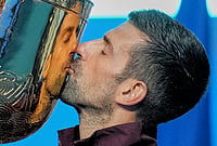 | Photo: AP/Achmad Ibrahim : Novak Djokovic, of Serbia, kisses the trophy after winning the men's singles final match against Alex De Minaur, of Australia, at the China Open tennis tournament in Beijing, Tuesday, Oct. 6, 2026. 