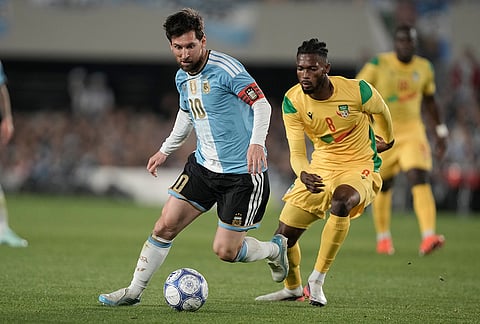 Argentina's Lionel Messi, left, is challenged by Benin's Imourane Hassane during Messi's final match for the national team, a soccer friendly against Benin, in Buenos Aires, Argentina, Tuesday, Oct.6, 2026.