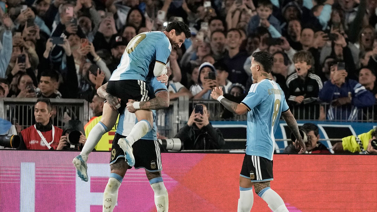 Argentina's Nicolas Otamendi, celebrates scoring his side's opening goal with teammate Argentina's Lionel Messi during Messi's final match for the national team, a soccer friendly against Benin, in Buenos Aires, Argentina, Tuesday, Oct.6, 2026. - (AP Photo/Natacha Pisarenko)
