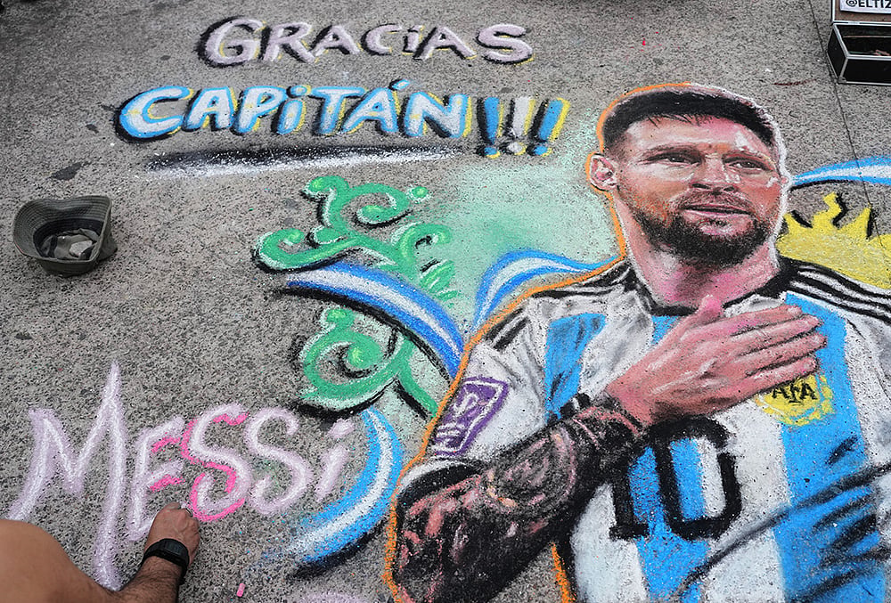 Argentina vs Benin Street artist Claudio Pampillon finishes a chalk portrait of Lionel Messi 