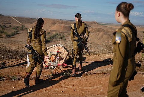 Israeli soldiers attend a memorial service marking the third anniversary of the Oct. 7, 2023, Hamas cross-border attack on Israel, near Kibbutz Nahal Oz, southern Israel, where female observer soldiers were killed, Wednesday, Oct. 7, 2026. 