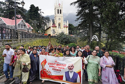 Bharatiya Janata Party (BJP) leaders and party workers march with a 'Seva Jyoti Yatra' banner during the 'Viksit Bharat Sankalp Sabha' programme at The Ridge, in Shimla, Himachal Pradesh, Wednesday, Oct. 7, 2026. The rally was organized as part of the party's nationwide campaign celebrating Prime Minister Narendra Modi completing 25 years in public office. 
