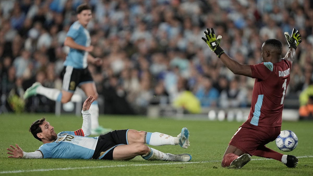 Argentina's Lionel Messi, left, makes an attempt to score during his final match for the national team, a soccer friendly against Benin, in Buenos Aires, Argentina, Tuesday, Oct.6, 2026. - (AP Photo/Natacha Pisarenko)