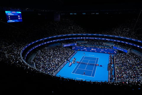 Spectators watch men's singles final match between Alex De Minaur, of Australia, foreground, and Novak Djokovic of Serbia at the China Open tennis tournament in Beijing, Tuesday, Oct. 6, 2026. 