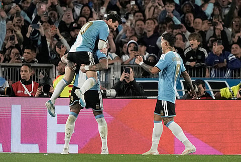 Argentina's Nicolas Otamendi, celebrates scoring his side's opening goal with teammate Argentina's Lionel Messi during Messi's final match for the national team, a soccer friendly against Benin, in Buenos Aires, Argentina, Tuesday, Oct.6, 2026. 