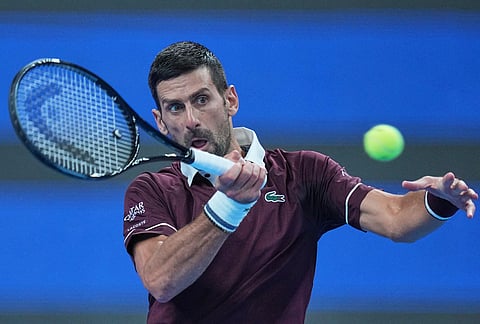 Novak Djokovic, of Serbia, returns a ball to, Alex De Minaur, of Australia, during the men's singles final match at the China Open tennis tournament in Beijing, Tuesday, Oct. 6, 2026. 