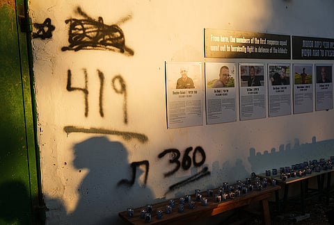 Shadows stretch across a memorial wall as Israel marks the third anniversary of the Oct. 7, 2023, Hamas cross-border attack in Kibbutz Kfar Aza, southern Israel, where many community members were killed and abducted, Wednesday, Oct. 7, 2026. 
