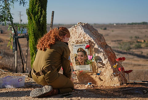 An Israeli soldier attends a memorial service marking the third anniversary of the Oct. 7, 2023, Hamas cross-border attack on Israel, near Kibbutz Nahal Oz, southern Israel, where female observer soldiers were killed, Wednesday, Oct. 7, 2026. 

