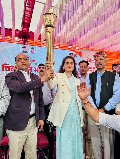 BJP MP Kangana Ranaut and Leader of the Opposition in Himachal Pradesh Assembly Jairam Thakur joint-hold a ceremonial torch during the 'Viksit Bharat Sankalp Sabha' programme, in Kullu. 

