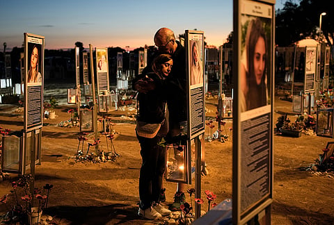 Benny and Maggy Solomon, parents of Hila Solomon, who was killed in the Oct. 7, 2023, Hamas attack on Israel, attend a memorial marking the third anniversary of the attack at the Nova music festival site near Kibbutz Reim, southern Israel, Wednesday, Oct. 7, 2026. 