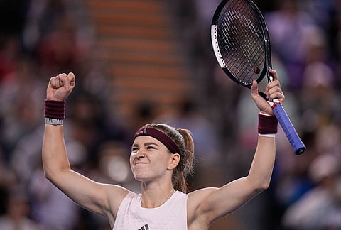 Karolina Muchova, of the Czech Republic, celebrates after defeating Naomi Osaka, of Japan, during the fourth round of the women's singles match at the China Open tennis tournament in Beijing, Tuesday, Oct. 6, 2026. 
