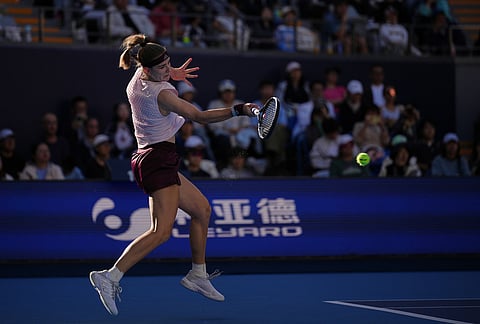 Karolina Muchova, of the Czech Republic, returns a ball to Naomi Osaka, of Japan, during the fourth round of the women's singles match at the China Open tennis tournament in Beijing, Tuesday, Oct. 6, 2026. 