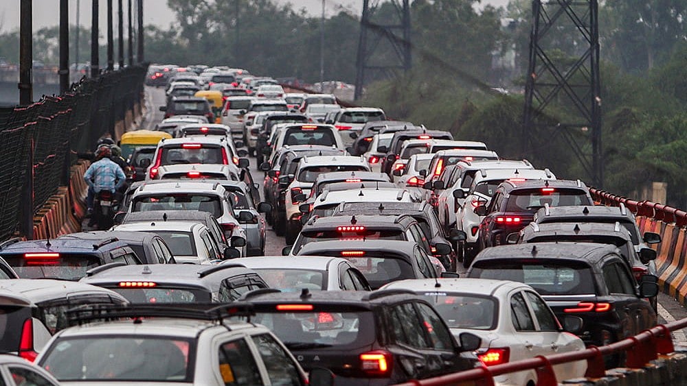 Vehicles stuck in traffic on the Barapullah flyover after monsoon rains, in New Delhi, Tuesday, July 7, 2026.  - | Photo: PTI