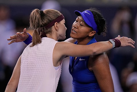 Karolina Muchova, of the Czech Republic, left, hugs Naomi Osaka, of Japan, after winning the fourth round of the women's singles match at the China Open tennis tournament in Beijing, Tuesday, Oct. 6, 2026. 