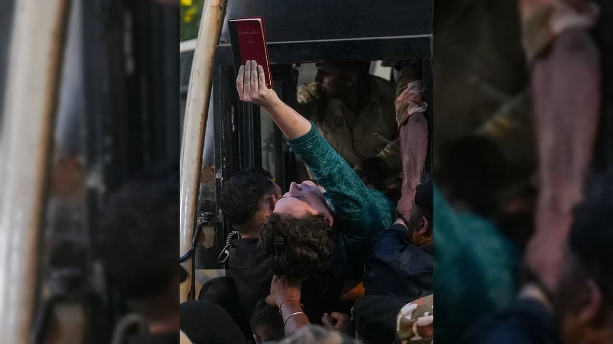 Congress leader Priyanka Gandhi Vadra holds a copy of the Constitution of India while being detained by the police during a sit-in protest against Chief Election Commissioner (CEC) Gyanesh Kumar at the roundabout near Shangri-La hotel, in New Delhi - PTI Photo/Karma Bhutia