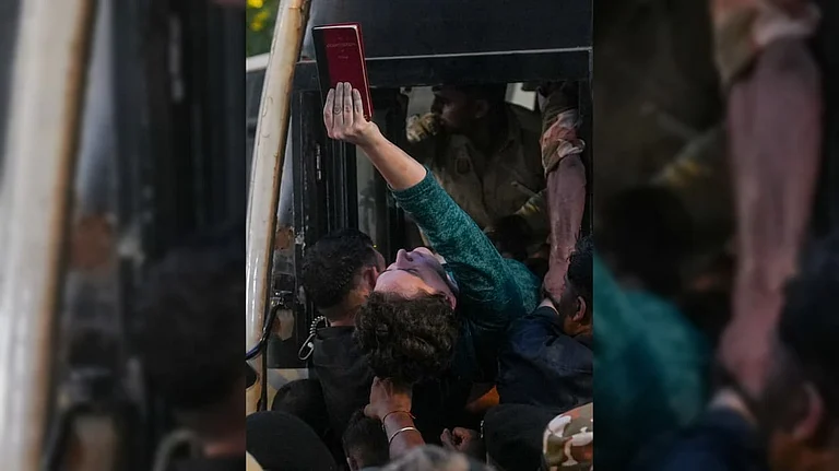 Congress leader Priyanka Gandhi Vadra holds a copy of the Constitution of India while being detained by the police during a sit-in protest against Chief Election Commissioner (CEC) Gyanesh Kumar at the roundabout near Shangri-La hotel, in New Delhi - PTI Photo/Karma Bhutia