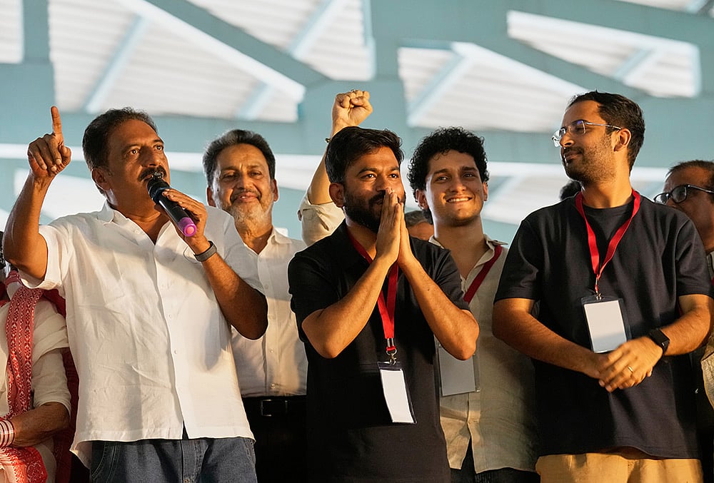 Indian actor Prakash Raj, left, speaks as Abhijeet Dipke
