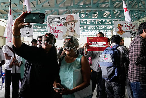 Supporters of India's Cockroach Janta Party display placards during a protest gathering demanding the resignation of the country's election chief Gyanesh Kumar, in Bengaluru, India, Thursday, Oct. 8, 2026. 
