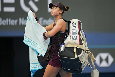 Iva Jovic of the United States leaves the court after losing against Iga Swiatek of Poland after the fourth round of the women's singles match at the China Open tennis tournament in Beijing, Wednesday, Oct. 7, 2026. 