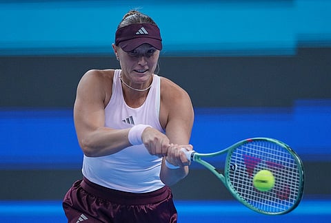 Alina Charaeva, of Armenia, returns a ball to Zheng Qinwen, of China during the fourth round of the women's singles match at the China Open tennis tournament in Beijing, Wednesday, Oct. 7, 2026.