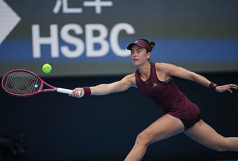 Iva Jovic of the United States stretches to return a ball against Iga Swiatek of Poland during the fourth round of the women's singles match at the China Open tennis tournament in Beijing, Wednesday, Oct. 7, 2026. 
