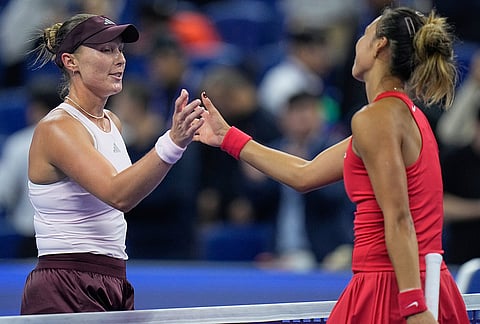 Zheng Qinwen, of China, right, shake hands with Alina Charaeva, of Armenia after defeating her in the fourth round of the women's singles match at the China Open tennis tournament in Beijing, Wednesday, Oct. 7, 2026.