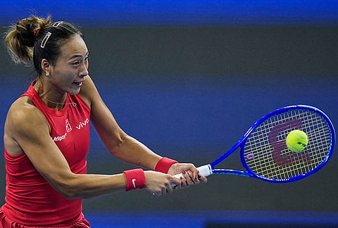 Zheng Qinwen, of China, returns a ball to Alina Charaeva, of Armenia during the fourth round of the women's singles match at the China Open tennis tournament in Beijing, Wednesday, Oct. 7, 2026. 
