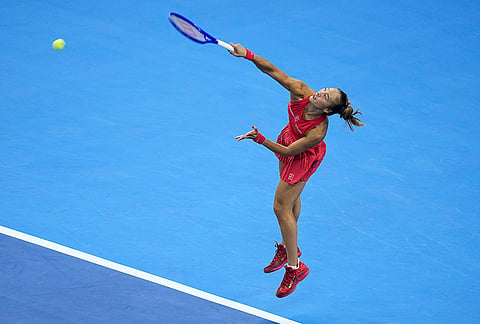 Zheng Qinwen, of China, serve to Alina Charaeva, of Armenia during the fourth round of the women's singles match at the China Open tennis tournament in Beijing, Wednesday, Oct. 7, 2026. 
