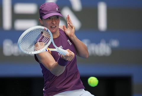 Iga Swiatek of Poland returns a ball to Iva Jovic of the United Statesduring the fourth round of the women's singles match at the China Open tennis tournament in Beijing, Wednesday, Oct. 7, 2026.
