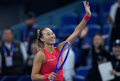 Zheng Qinwen, of China, celebrates after defeating Alina Charaeva, of Armenia in the fourth round of the women's singles match at the China Open tennis tournament in Beijing, Wednesday, Oct. 7, 2026. 