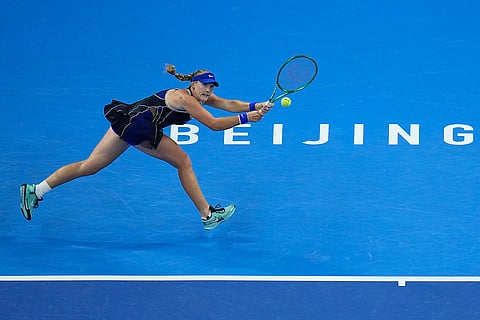 Mirra Andreeva, of Russia, returns a ball to Ekaterina Alexandrova, of Russia during the quarterfinals of the women's singles match at the China Open tennis tournament in Beijing, Thursday, Oct. 8, 2026.