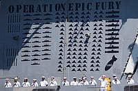 Watch In Photos: Hugs, Kisses And Emotional Reunions As USS Abraham Lincoln Returns Home After 10 Months | Photo: AP/Gregory Bull : Sailors stand aboard the USS Abraham Lincoln aircraft carrier as it returns to Naval Air Station North Island after deployment Thursday, Oct. 8, 2026, in Coronado, Calif.