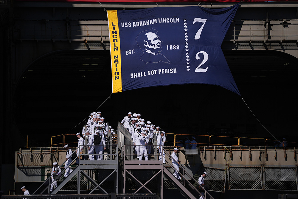 Sailors disembark the USS Abraham Lincoln aircraft carrier after it returned to Naval Air Station North Island after deployment Thursday, Oct. 8, 2026, in Coronado, Calif.