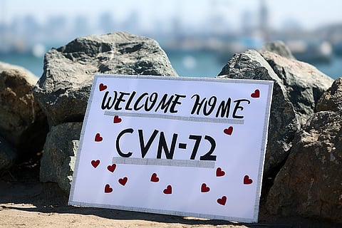 A welcome sign is seen as the USS Abraham Lincoln aircraft carrier returns to the San Diego Bay after deployment Thursday, Oct. 8, 2026, in San Diego.