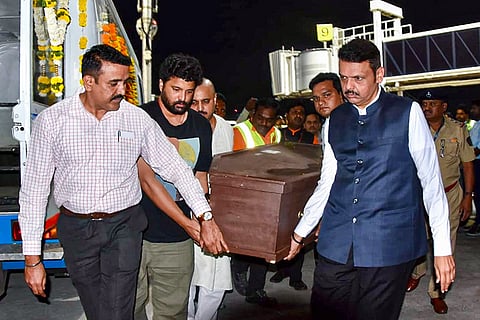 In this image posted on Oct. 8, 2026, Maharashtra Chief Minister Devendra Fadnavis and members of late actor Nana Patekar carry the latter's mortal remains upon arrival at the airport, in Pune.