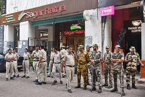Police and security personnel stand guard outside Sagar Ratna restaurant, ahead of the INDIA bloc's march to Rashtrapati Bhavan to seek President Droupadi Murmu's intervention over its demand for Chief Election Commissioner Gyanesh Kumar's resignation, at Janpath, in New Delhi. More than 20,000 police and paramilitary personnel have been deployed across central Delhi, where the Cockroach Janata Party (CJP) too has announced another protest on Saturday, this time against Kumar.