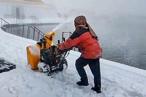 A worker operates a snowcutter machine to clear snow-covered pathways near the high-altitude Sikh shrine of Shri Hemkund Sahib, in Chamoli, Uttarakhand.