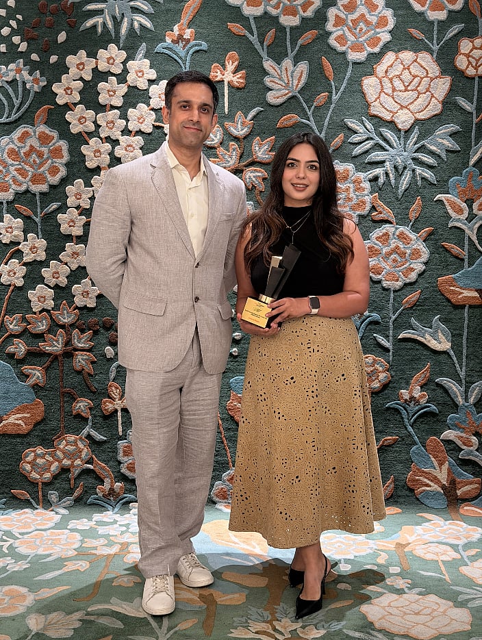 Rishab Mehra and Disha Bhatnagar posing with the Outlook Business Spotlight Achievers Award