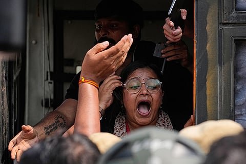A female journalist is detained and taken away in a police van during a protest demanding the resignation of Chief Election Commissioner Gyanesh Kumar in New Delhi, India, Saturday, Oct. 10, 2026.