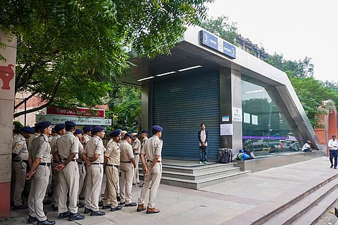 Security personnel stand guard near Janpath Metro Station as heavy police deployment and entry restrictions are enforced ahead of a planned protest by Cockroach Janta Party (CJP) members, in New Delhi, Saturday, Oct. 10, 2026. 